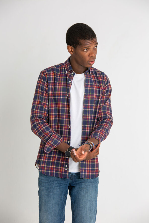 Modelo joven con camisa de cuadros de color granate y azul